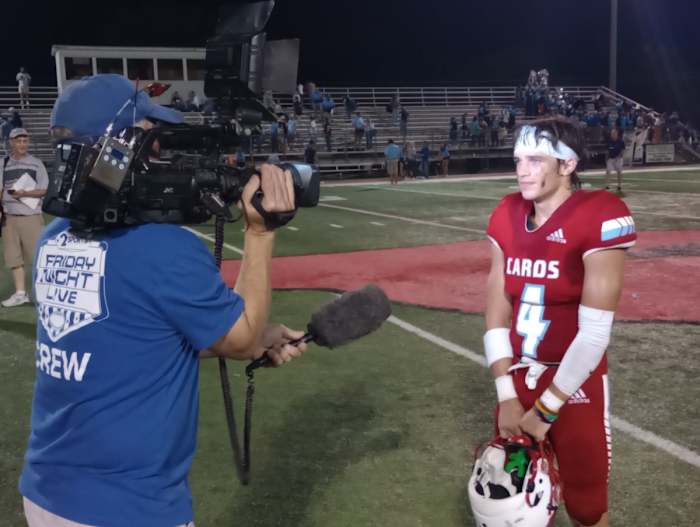 Collinsville senior Hudson Henslick (right) is interviewed by a local TV crew after his 3-TD performance in a 27-14 win against Bartlesville on Sept. 15, 2023.